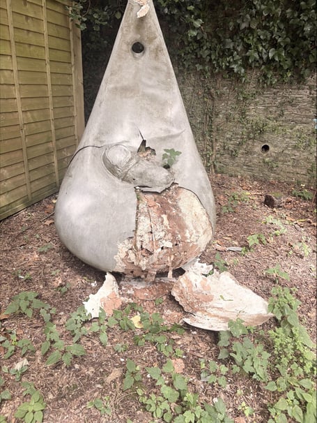 Statue damaged beyond repair in a memorial garden at Derriford Hospital.